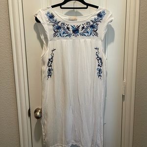 White dress with blue embroidered details